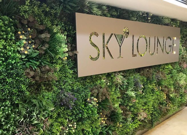 artificial green wall with signage