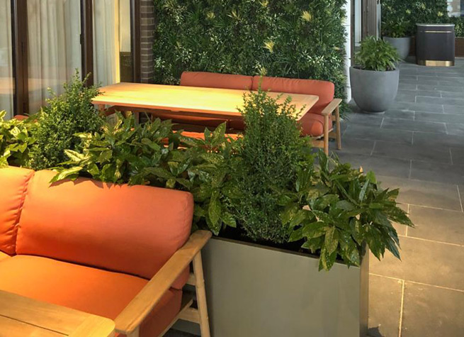 indoor planter filled with artificial foliage plants
