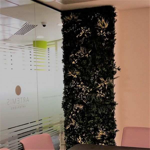 Slim green wall added to a meeting room to improve the general ambiance